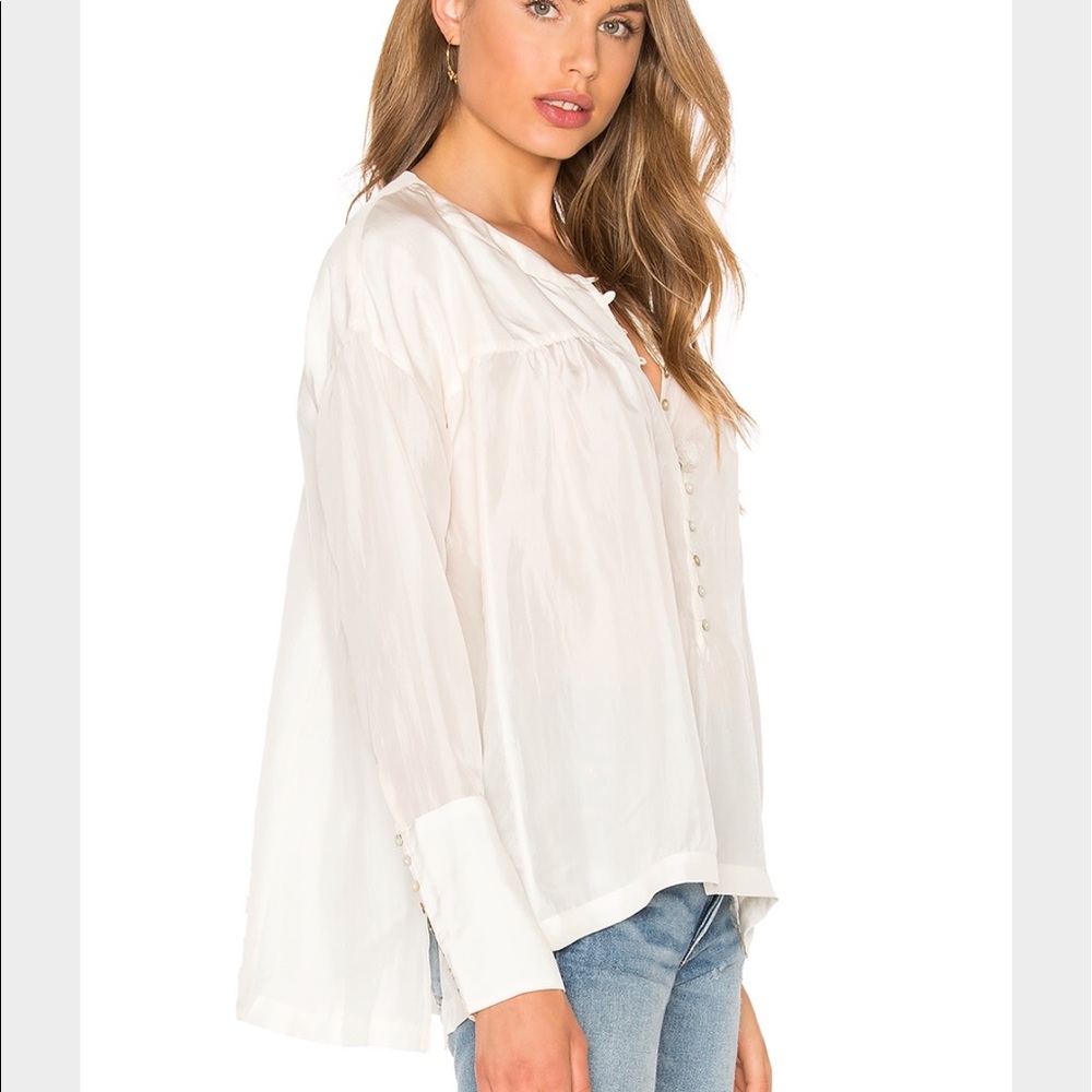 Free people cream colored flared blouse-