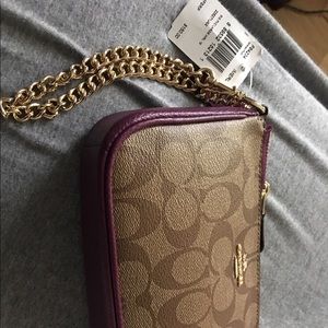 Auth Coach clutch brand new with tags asking $75.