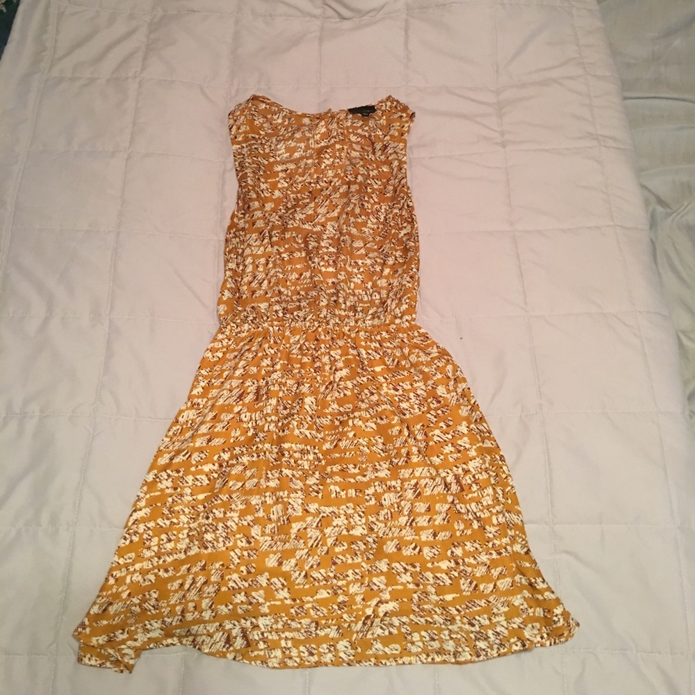 Tan printed dress with button down open flow back.