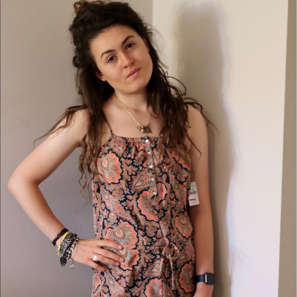 This silky romper is eclectic but chique! Has Tags