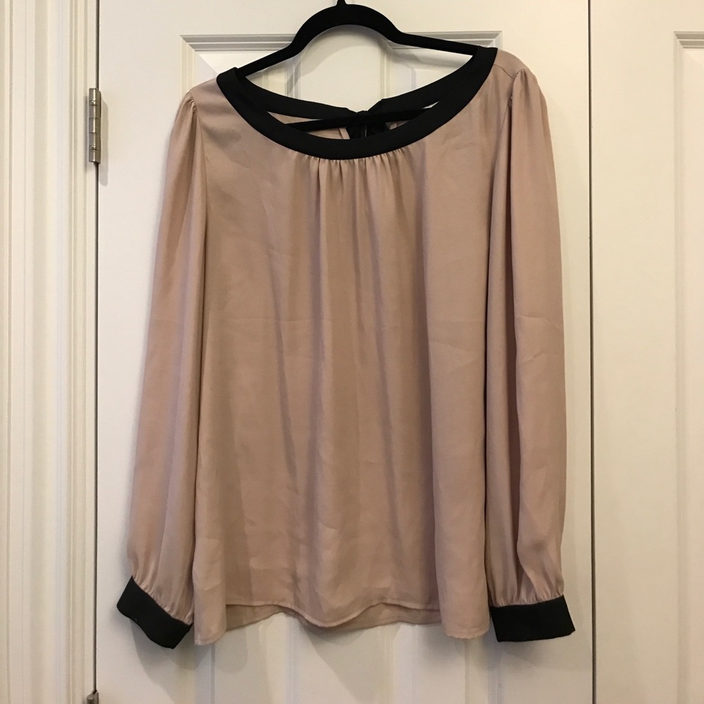 Tan and black blouse.