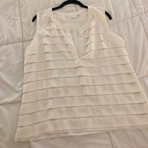 Sleeveless ivory ruffled blouse