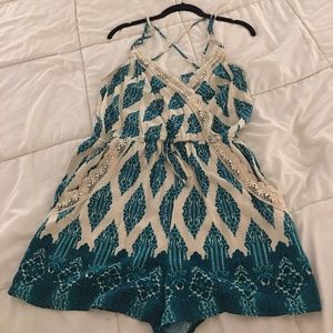 Cream spaghetti strap romper with green design