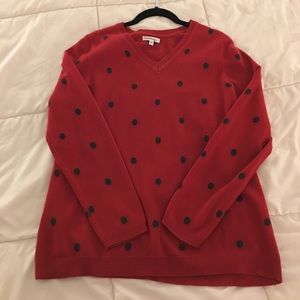 Red v-neck sweater with black polka dots