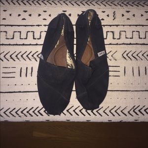Black TOMS shoes.