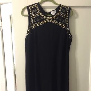 Black cocktail dress with gold hardware