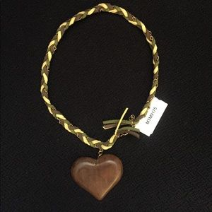 Leather braided wooden heart necklace .