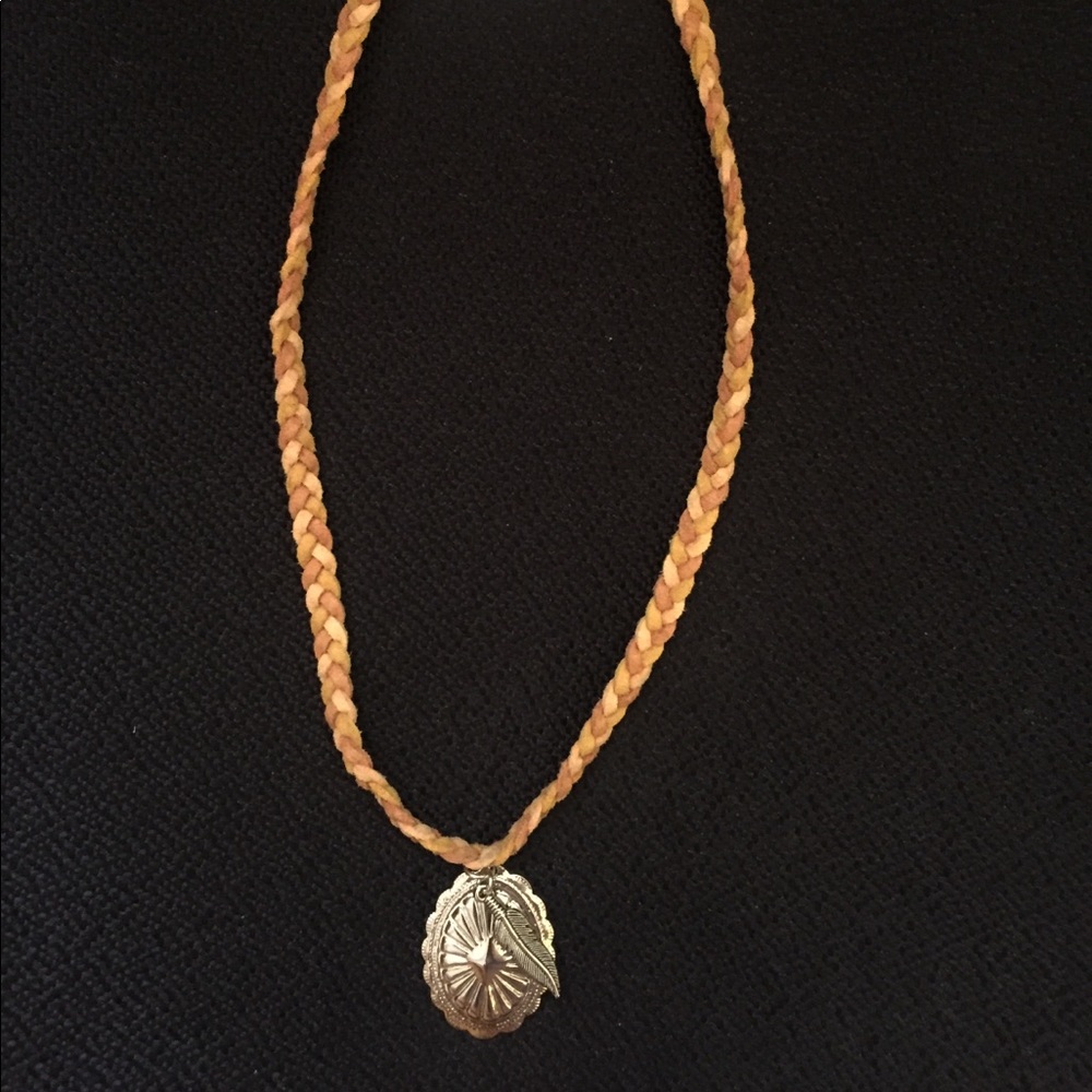 Leather braided bohemian feather necklace .
