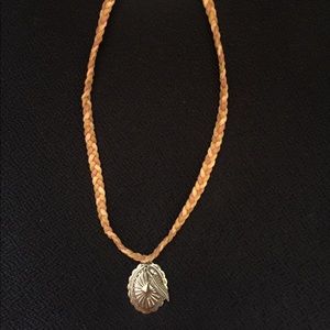 Leather braided bohemian feather necklace .