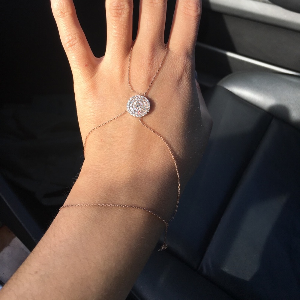 Rose gold hand chain bracelet attached with ring