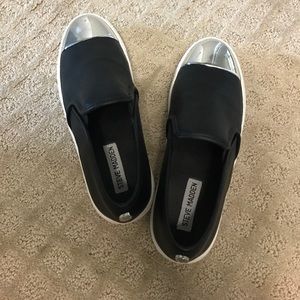 Steve Madden black slip ons.