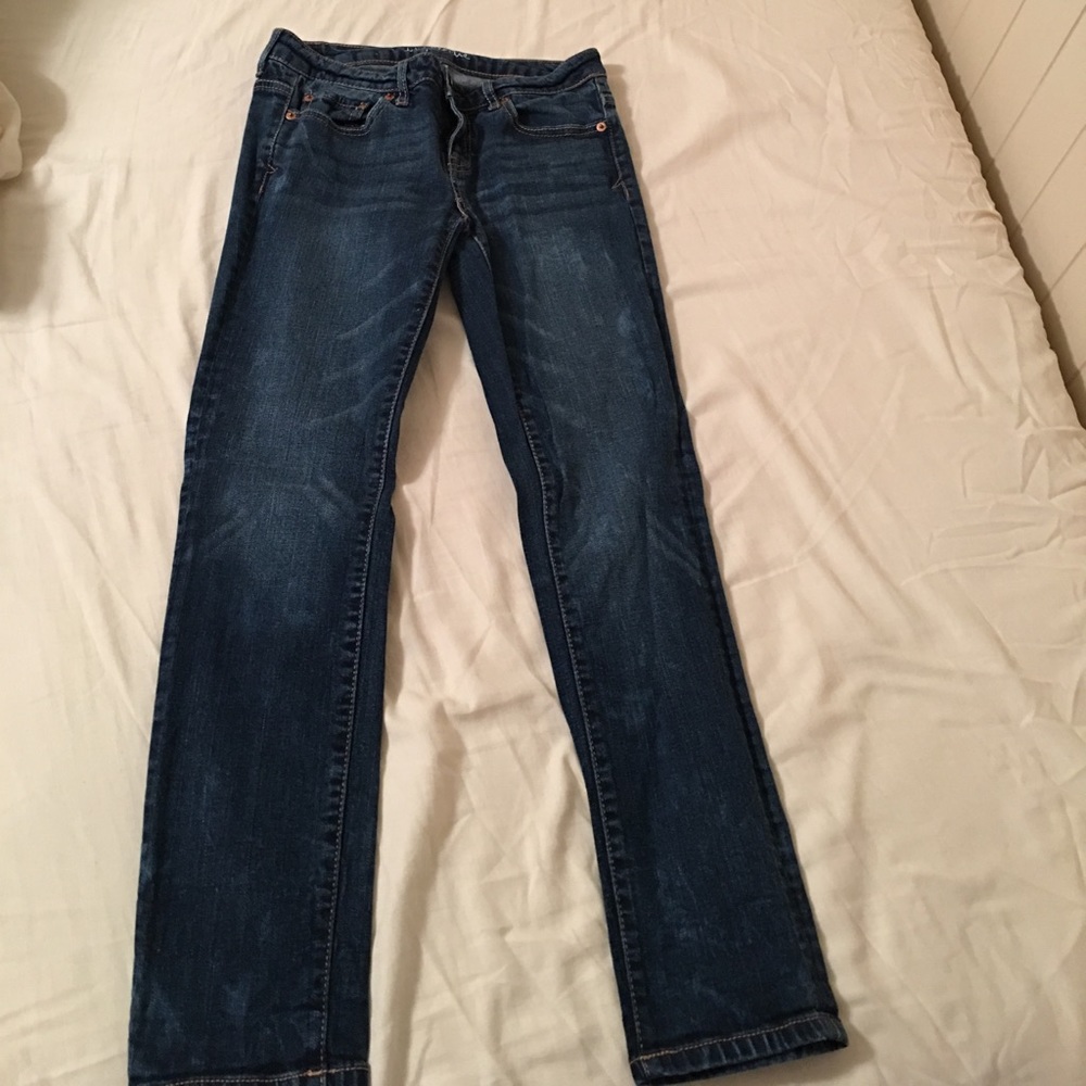 These are some dark wash capris with bleach stains