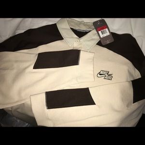 Long sleeve collared Nike shirt.