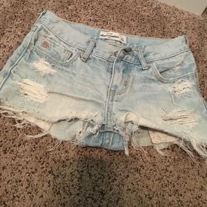 Light blue distressed jeans with lace pockets