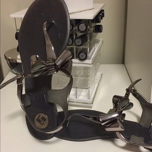 Brand new pewter flat sandals with bow.