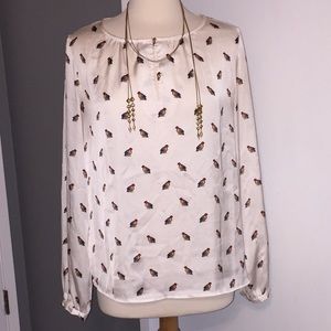 Parrot blouse with gold button.