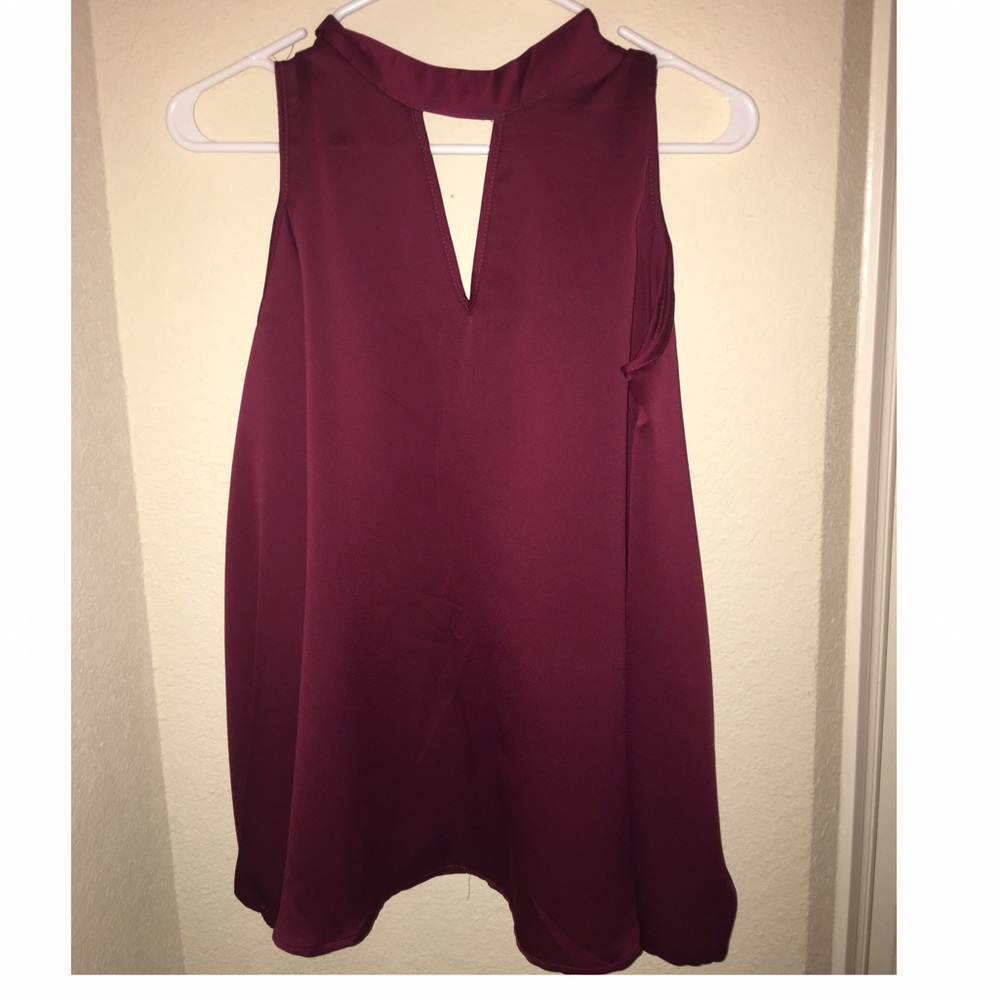 A maroon long sleeve off the shoulder blouse