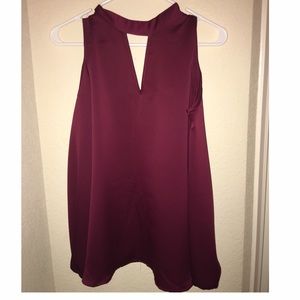 A maroon long sleeve off the shoulder blouse