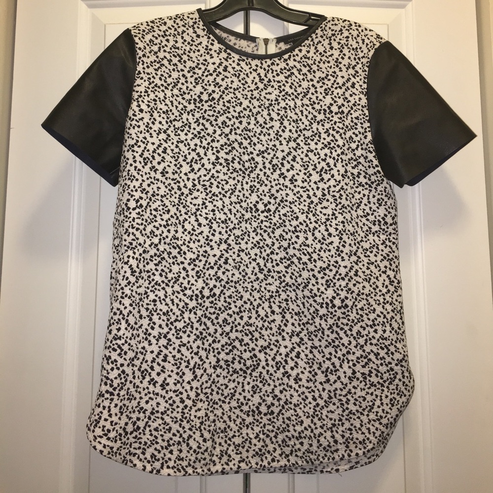 Super cute blouse with faux leather sleeves!