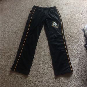 Black and gold track pants