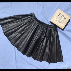 Black fake leather mini pleated skirt.