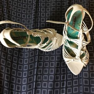 Strappy white Michael Antonio heels