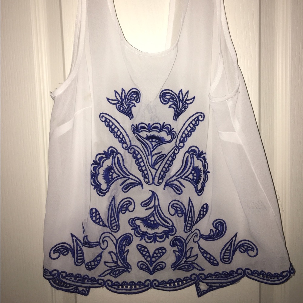 White top with blue design
