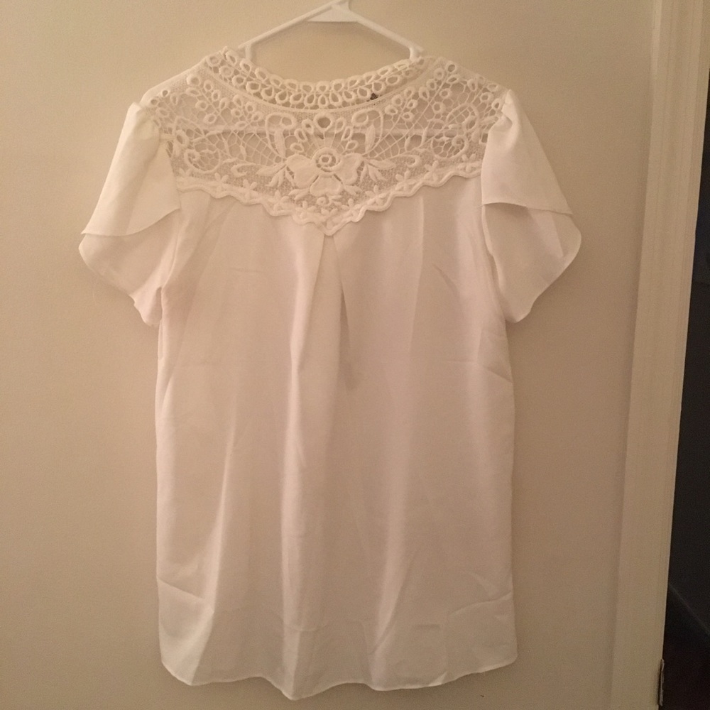 White blouse with lace design around neck