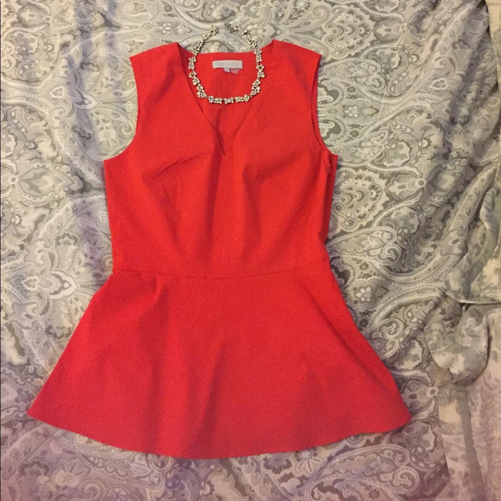 red peplum sleeveless top with cutout (in back)