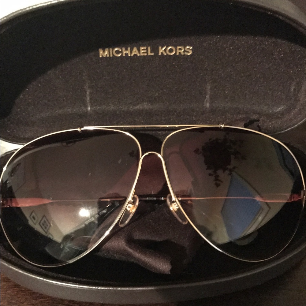 Gold Michael Kors aviator sunglasses.