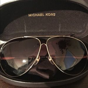 Gold Michael Kors aviator sunglasses.