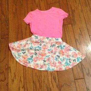 A hot pink T-Shirt, with a waste flower skirt