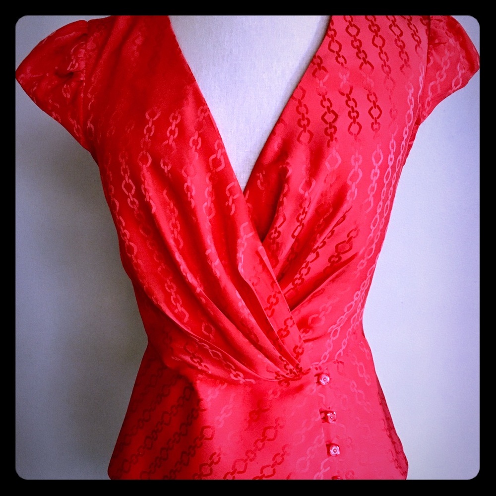 Trina Turk cap sleeve plunging blouse.