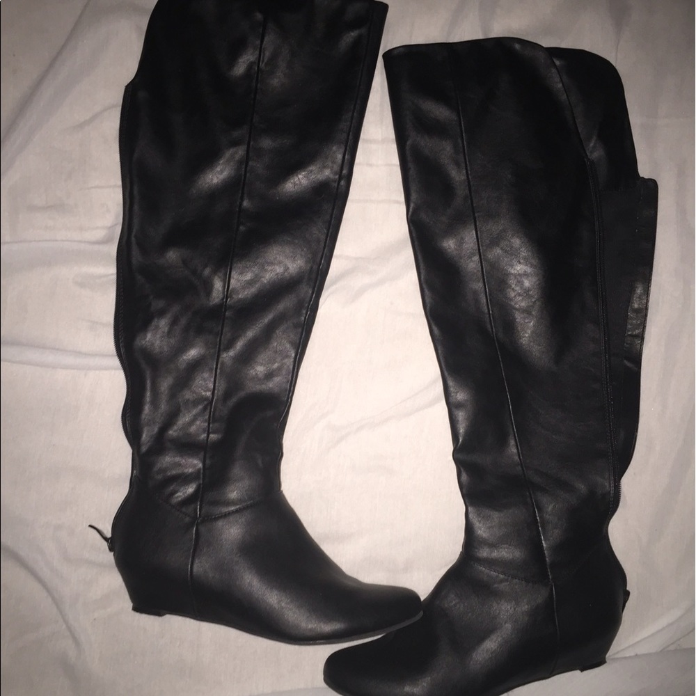 Black knee-high boots with hidden wedge.