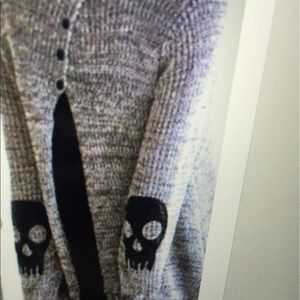Skull Sweater with sheer black blouse.
