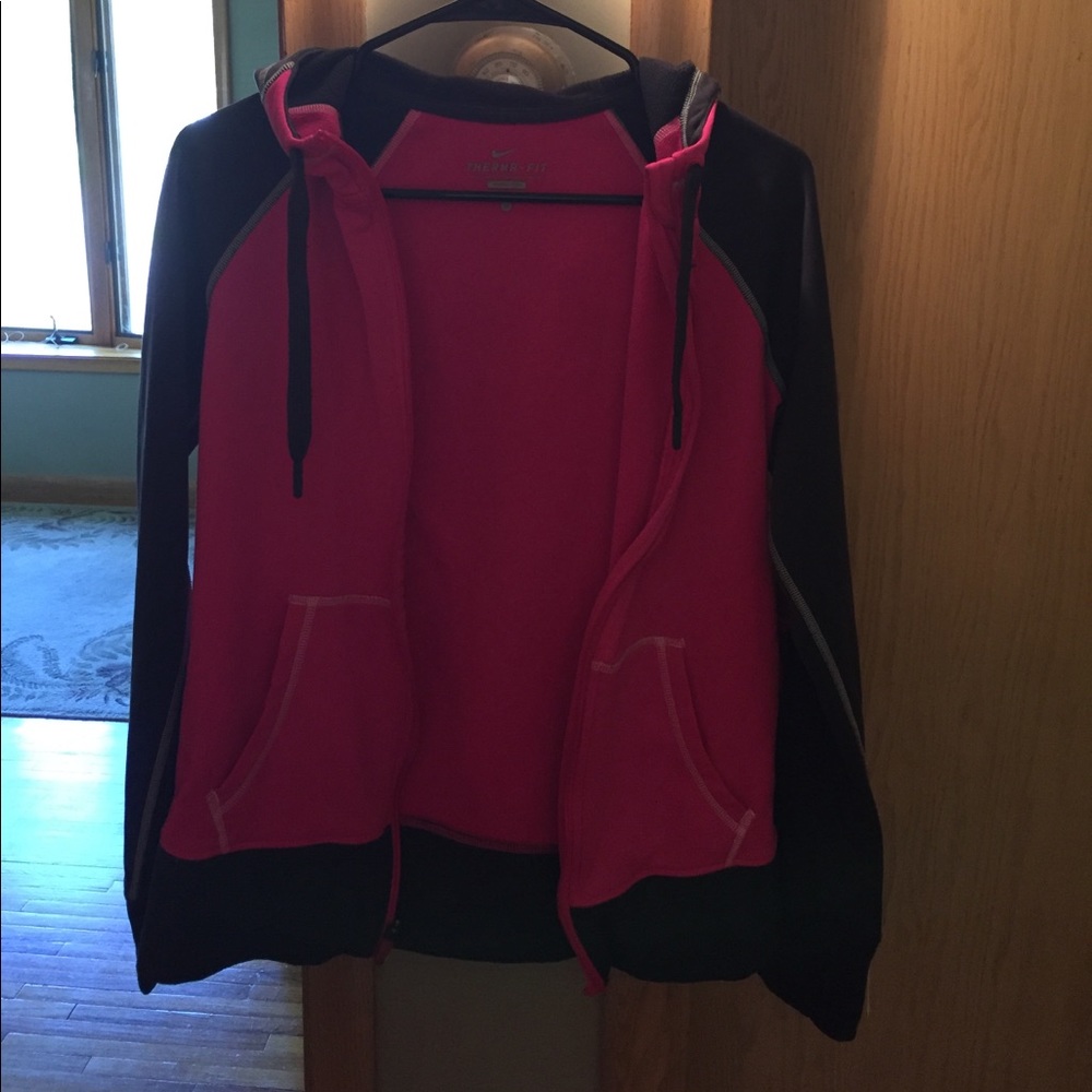 Pink and gray zip up Nike sweatshirt.