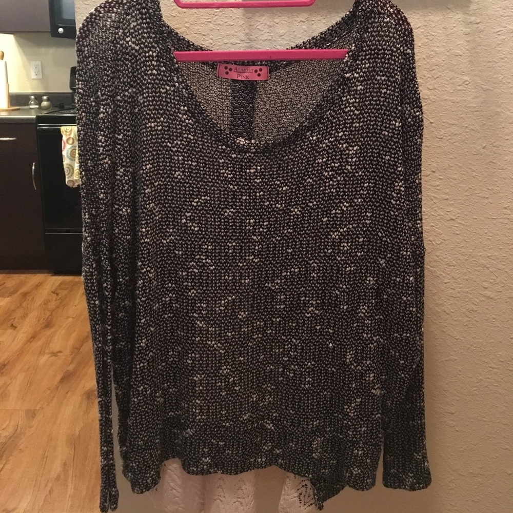 Black and cream thin, long sleeved sweater.