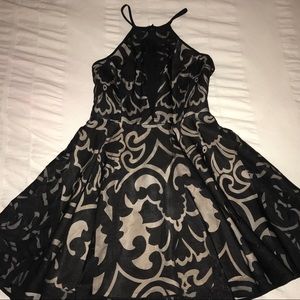 Black mesh dress with cream underlay.