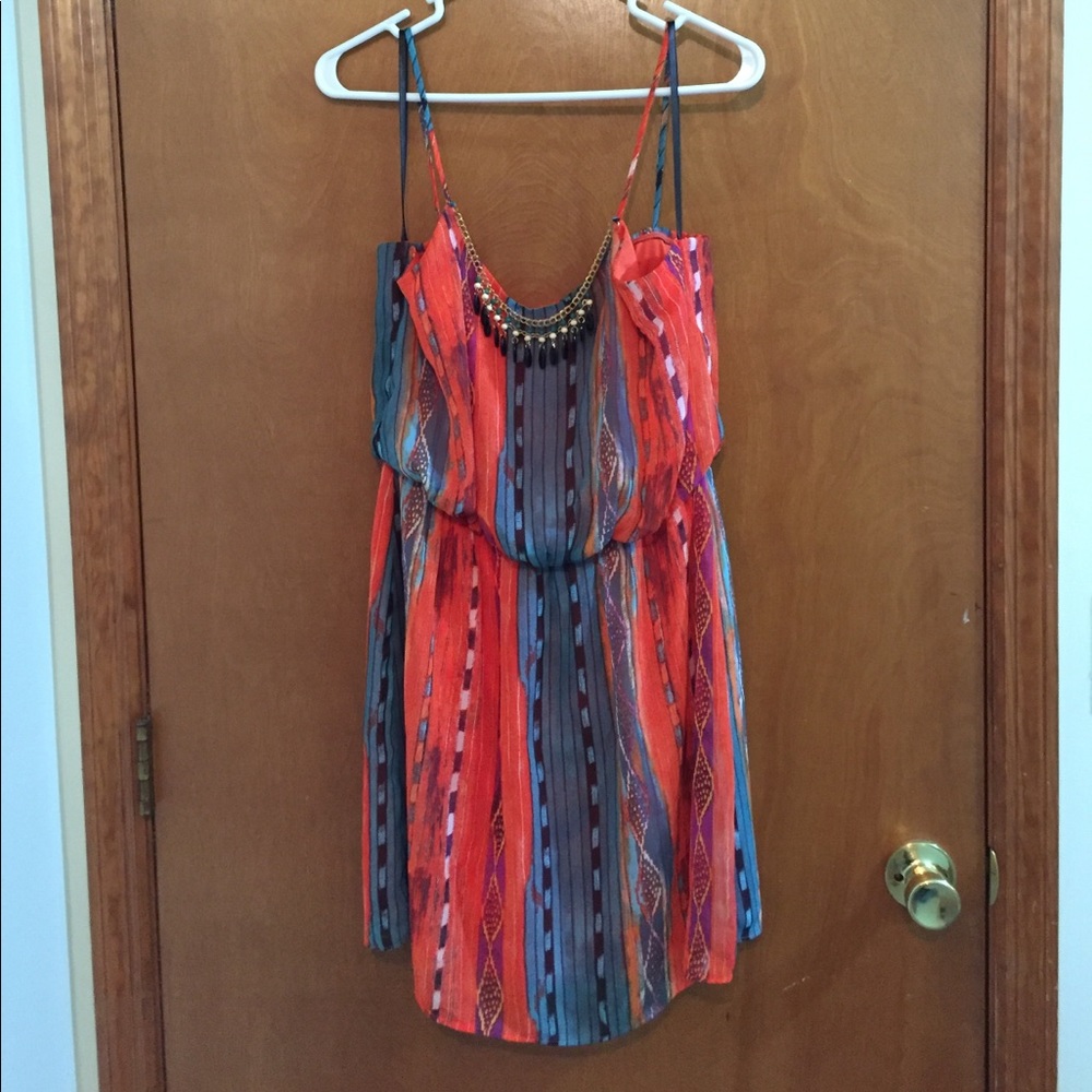 Colorful dress with jazzy jewelry attached.