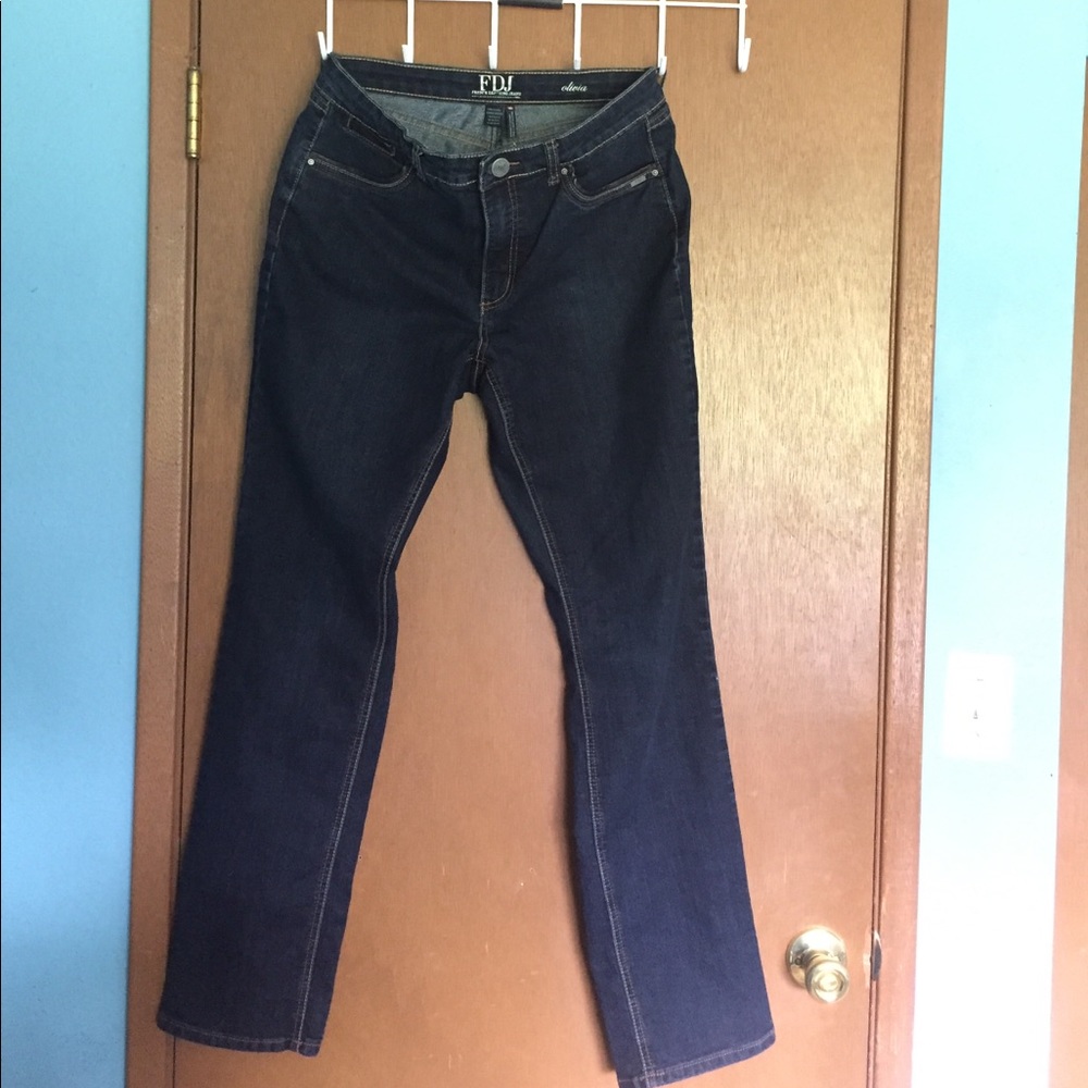 Blue jeans with leather detail on pockets