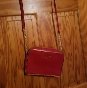 red Michael kors cross body and wristlet.