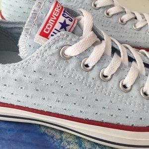 Powder blue eyelet converse with red trim