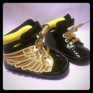 Gold and black winged crib shoes