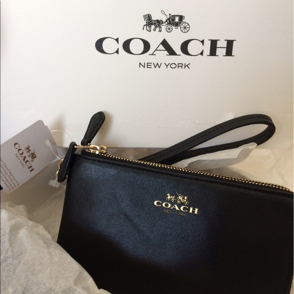 Brand new Coach wristlet black and gold
