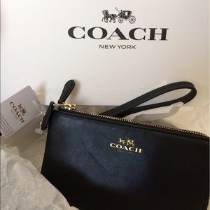 Brand new Coach wristlet black and gold