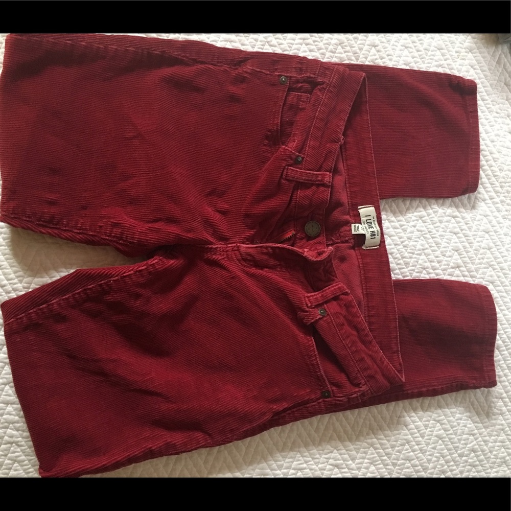 Red corduroy pants, waist length, skinny leg.