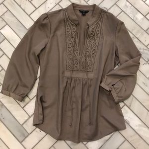Silky taupe blouse with placket detailing.