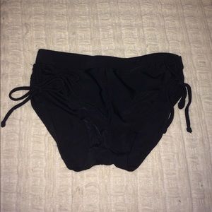 Black bathing suit bottoms with ties on the sides