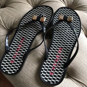 Coach black and gold jelly flip flops