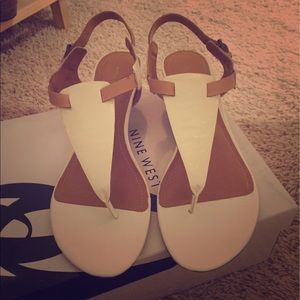 White and tan low wedge sandals.